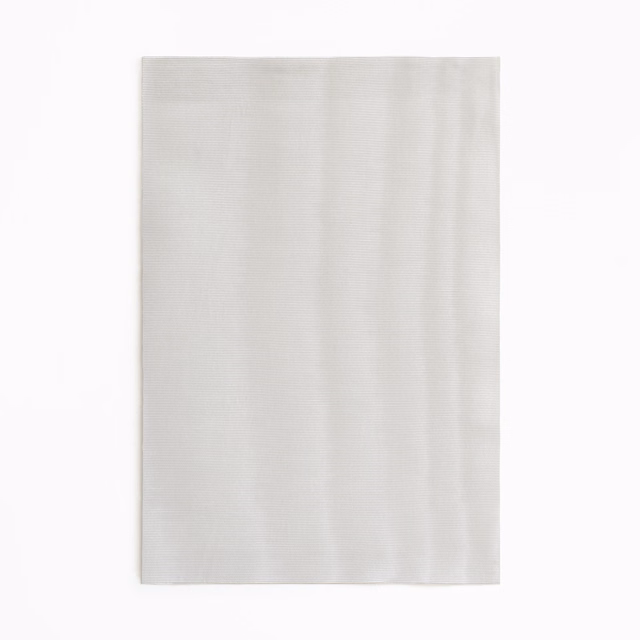 Pale silver-grey curtain fabric with subtle vertical tonal striations and soft sheen