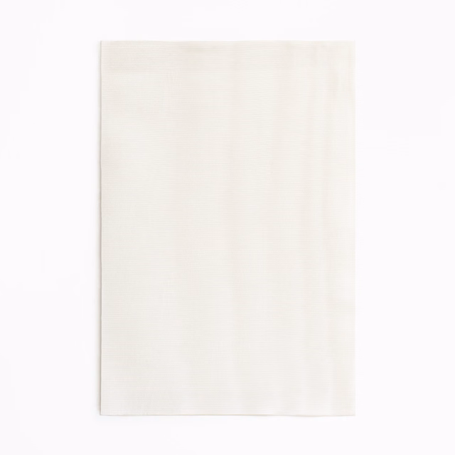 Soft ivory curtain fabric swatch with barely visible vertical tonal movement
