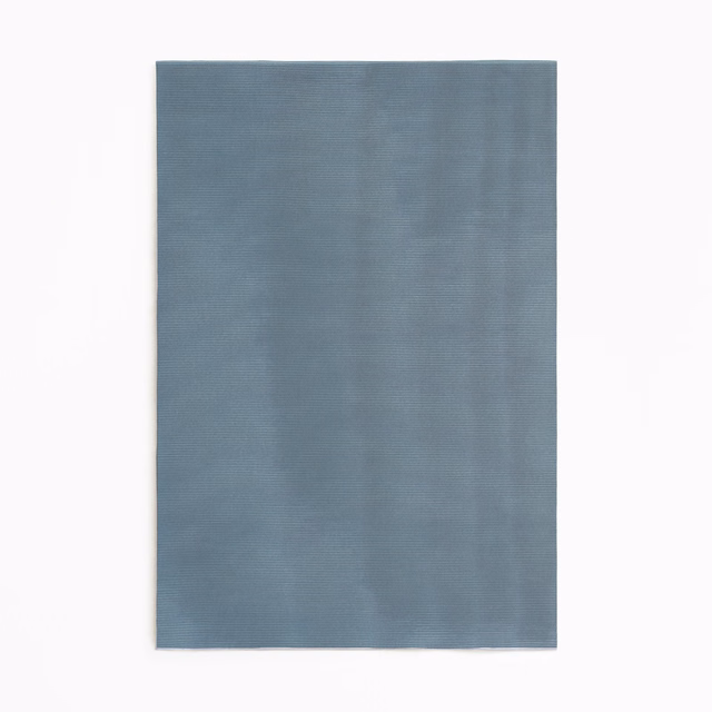 Cool blue-grey curtain cloth with subtle tonal striations and softly textured surface