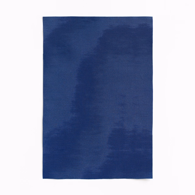Deep ink-blue curtain fabric with softly mottled tonal bands and a fine woven surface
