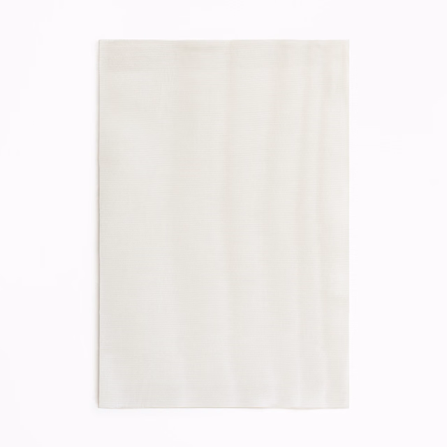 Pale pearl-ivory curtain fabric with subtle vertical tonal texture