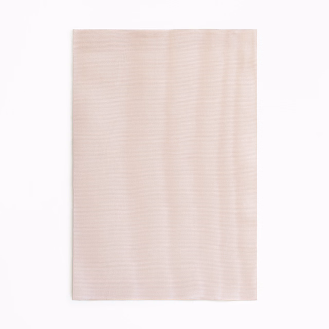 Pale blush rose fabric swatch with subtle vertical striations and tonal depth