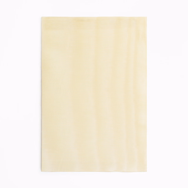Pale sandy ivory fabric swatch with subtle vertical striations and soft luminous texture
