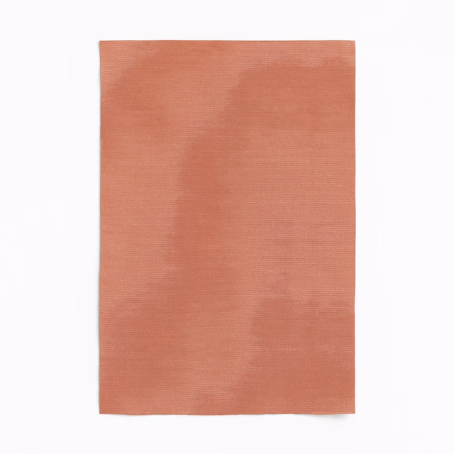 Dusty salmon textile with a softly brushed, clouded surface and fine weave