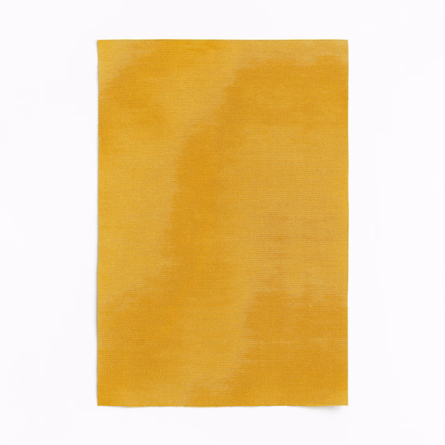 Warm ochre-gold curtain fabric with fine weave and softly mottled tonal shading