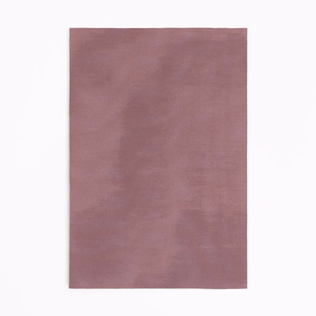 Dusty vieux rose curtain fabric with a soft, subtly rippled woven surface