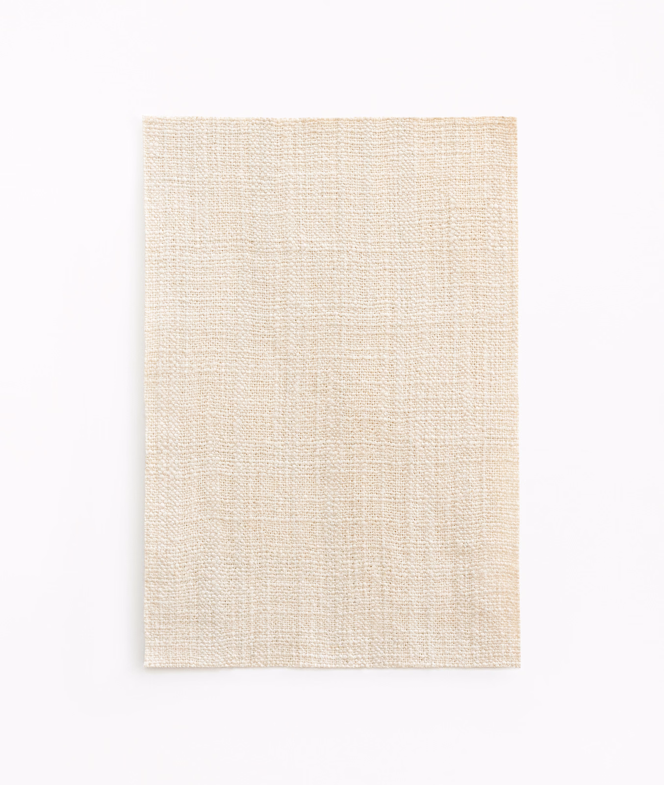 Warm ivory curtain fabric showing a fine crosshatched woven texture