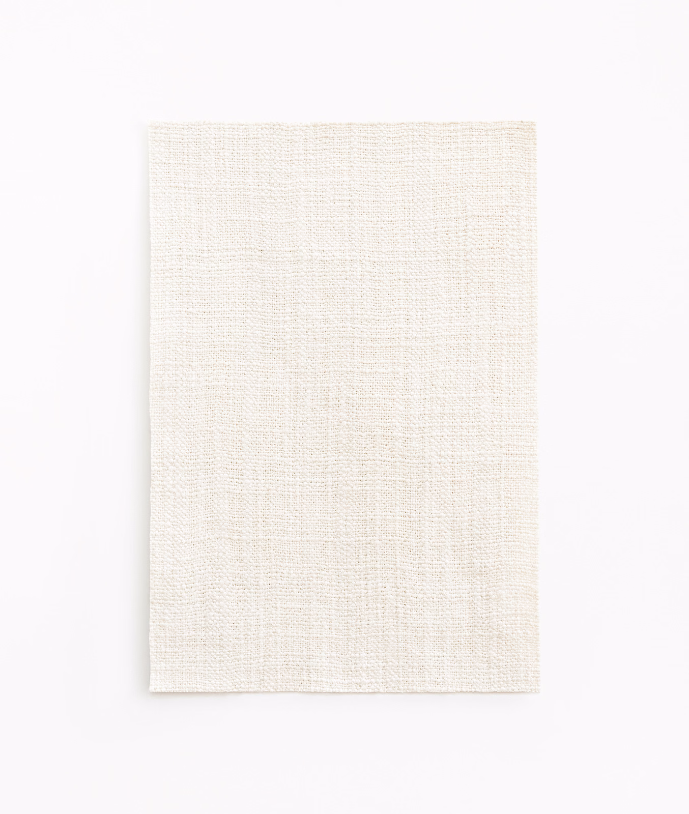 Pale ivory woven textile with fine slub texture and softly varied surface