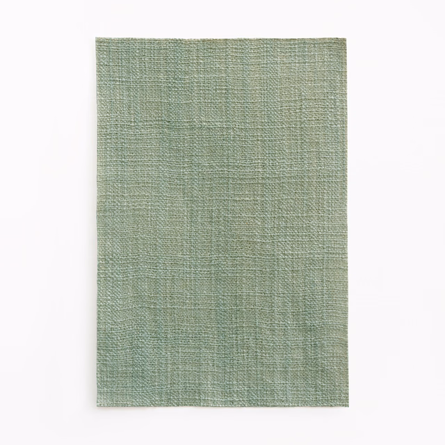 Pale celadon green fabric with a fine, subtly crosswoven textured surface