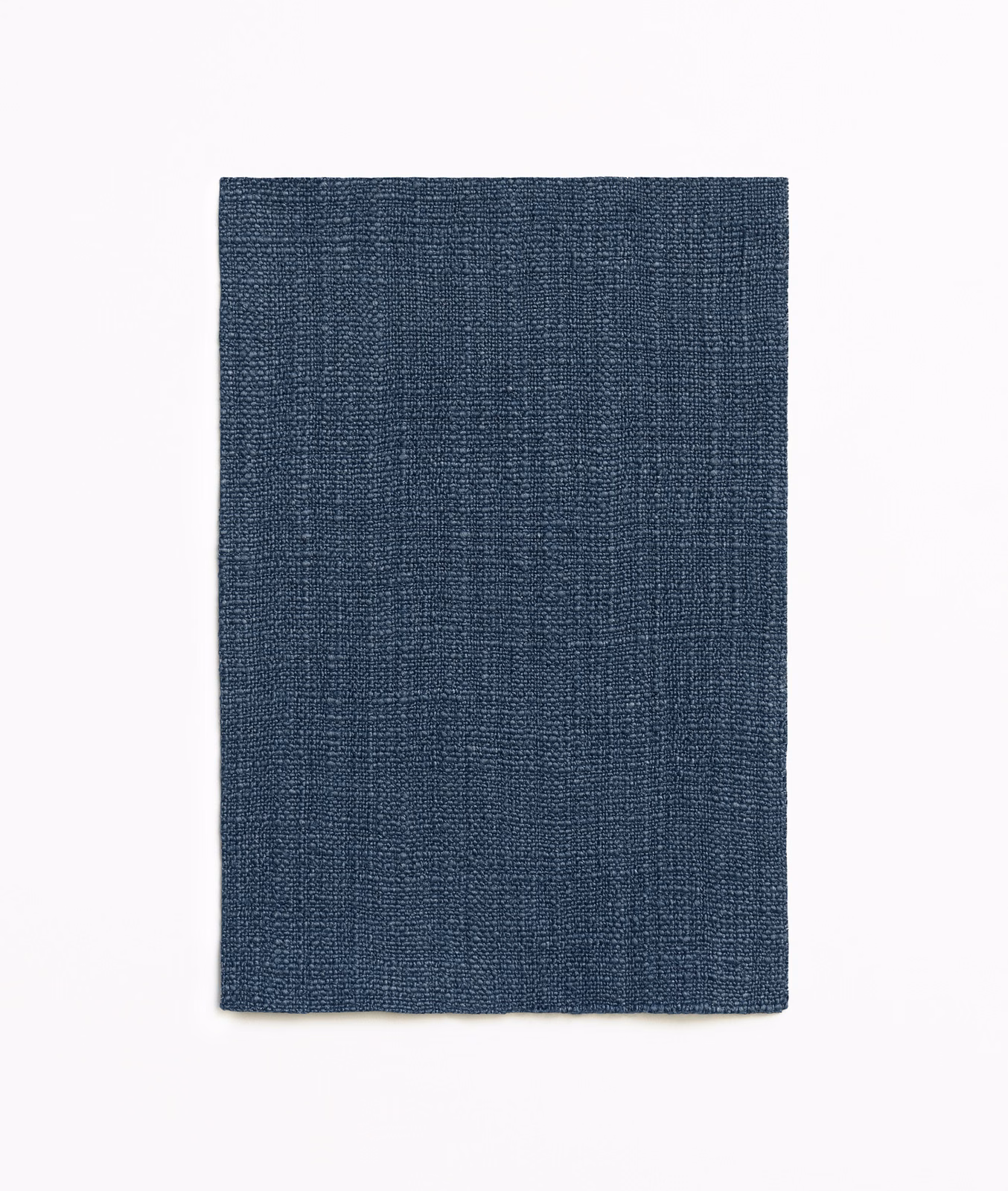 Deep indigo curtain fabric with a fine, tightly crosshatched woven texture
