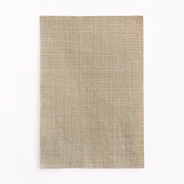 Warm stone-taupe fabric swatch with a finely textured, irregular plain weave