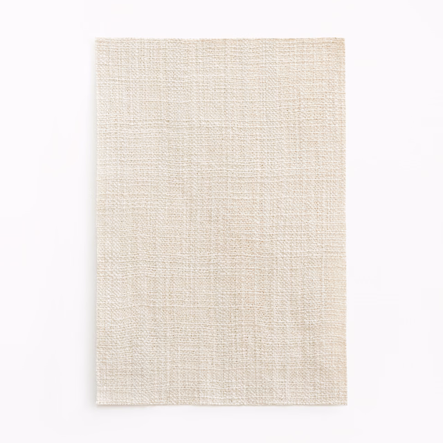 Warm ivory-cream curtain swatch with fine irregular crossweave and subtle tactile texture