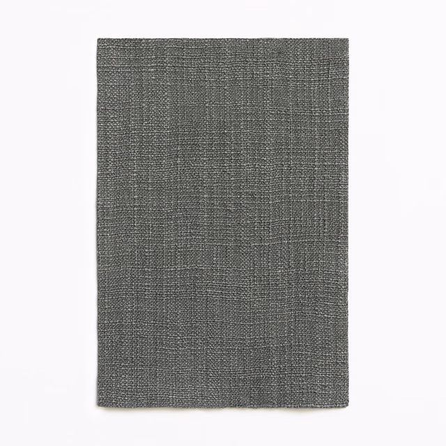 Charcoal-grey woven textile with a subtle irregular grid and fine salt-and-pepper texture