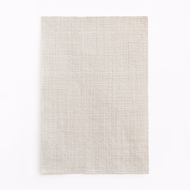 Pale pearl-grey woven swatch with fine crosshatched texture and subtle tonal flecks