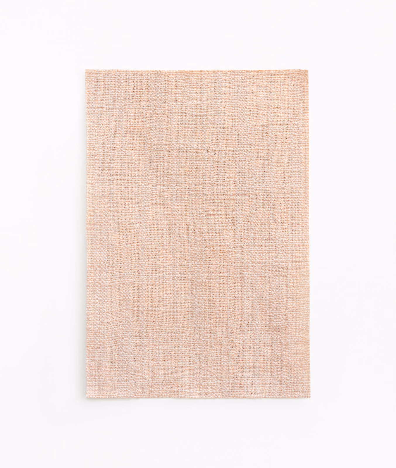 Pale blush-pink curtain fabric with a fine crosshatched woven surface