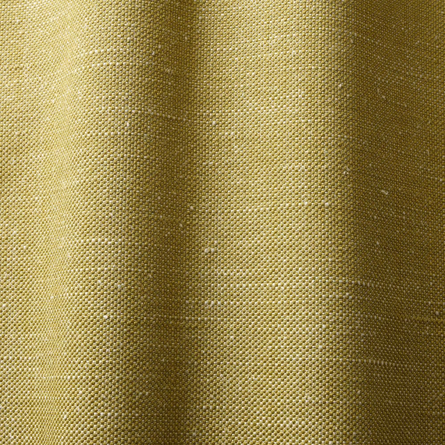 Close-up of tightly woven muted lemon-lime fabric with olive shading in vertical folds
