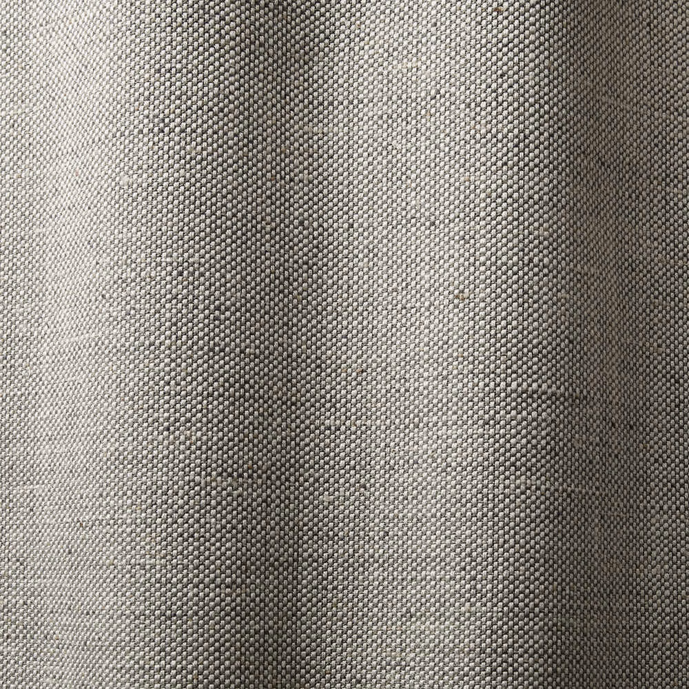 Close view of dense sand-grey woven fabric with subtle tonal texture