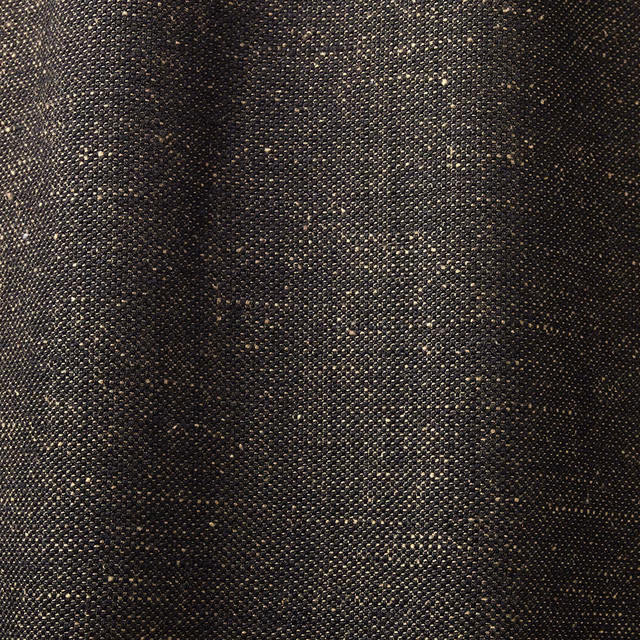 Dense charcoal-black woven curtain fabric with tiny bronze flecks and a pebbled texture