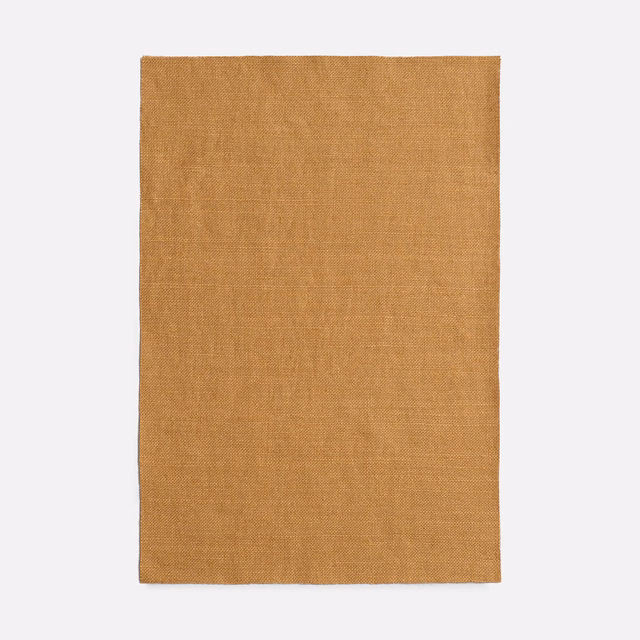 Warm amber-brown woven swatch with a fine, softly irregular surface