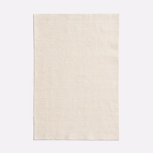 Pale ivory Caolino swatch showing a fine, softly varied woven surface