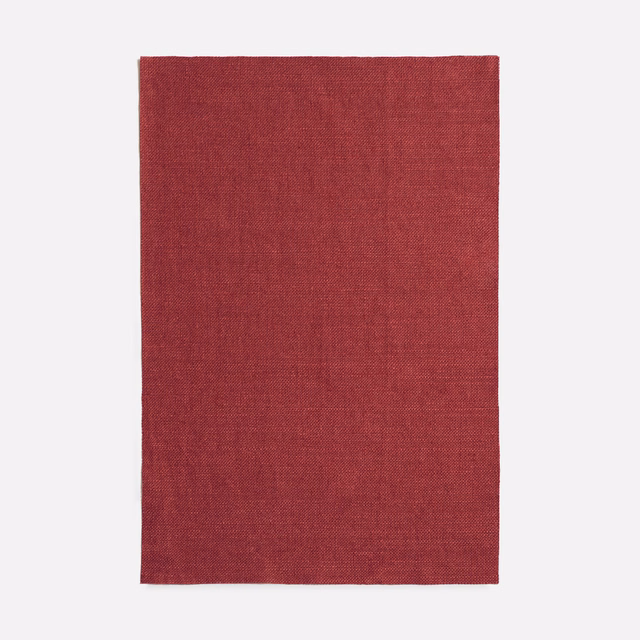 Deep cherry-red plain woven fabric with a subtly mottled textured surface