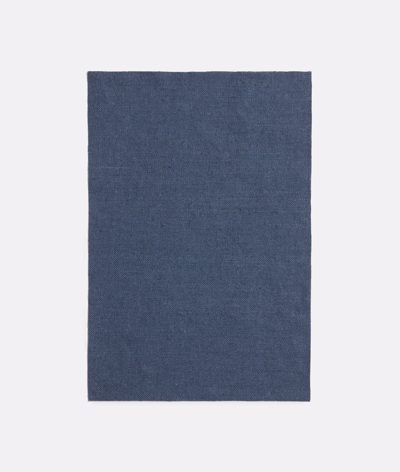 Muted slate-blue plain weave showing a fine, subtly tonal textile texture