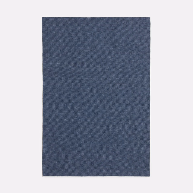 Muted slate-blue plain weave showing a fine, subtly tonal textile texture