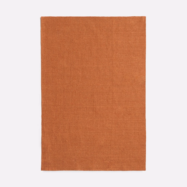 Warm burnt-terra plain woven fabric with a subtle fine-textured surface
