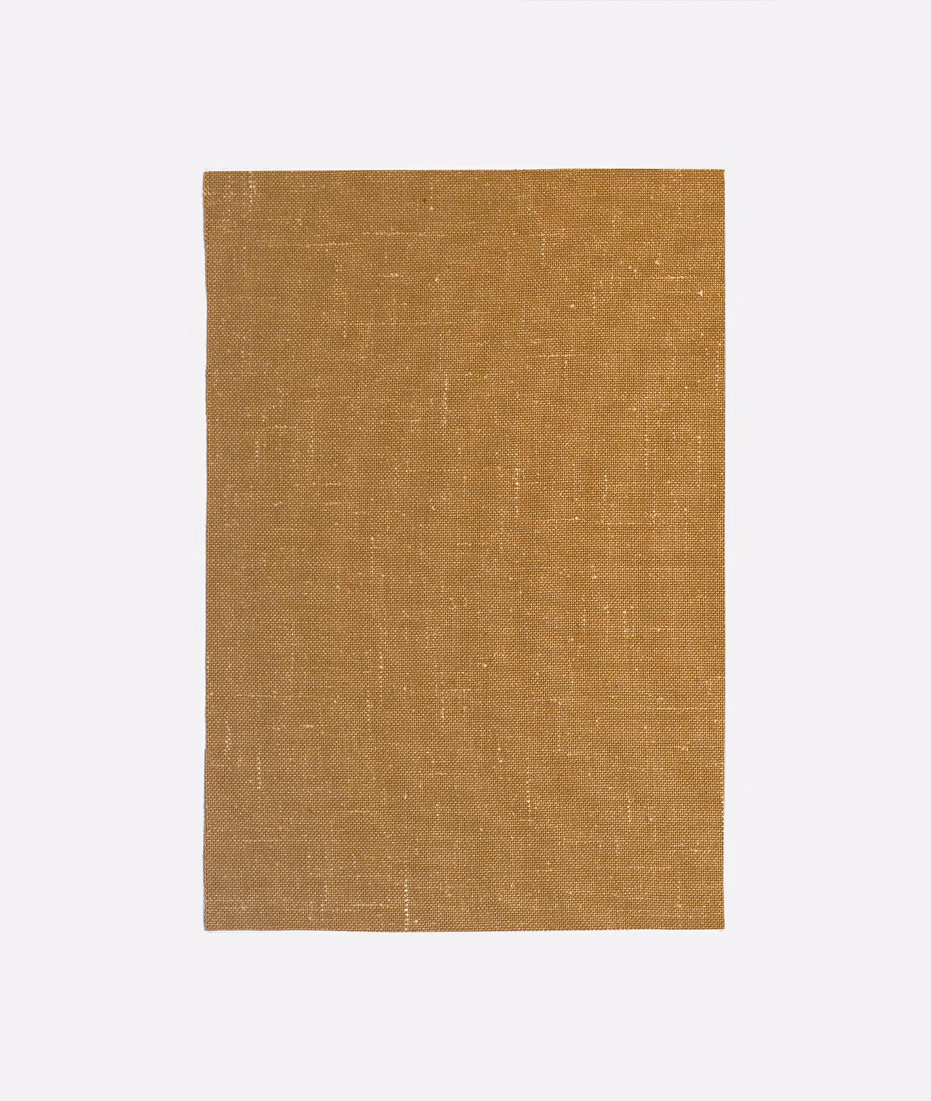 Warm curry ochre plain-weave textile with subtle slub lines and pale flecks
