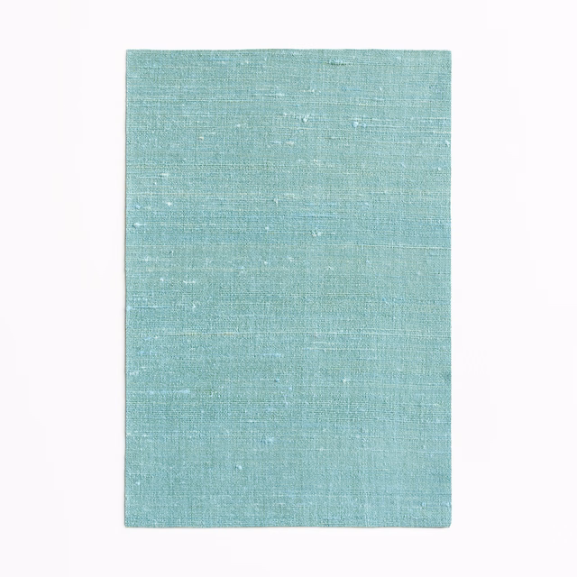 Pale aqua-teal woven fabric with subtle slub texture and pale horizontal flecks