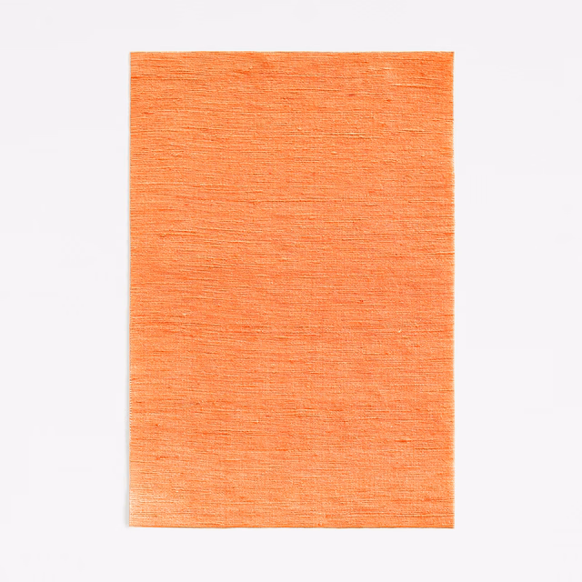 Warm tangerine orange fabric swatch with fine horizontal woven texture