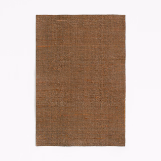 Warm chestnut-brown fabric showing a fine, closely woven crosshatch texture