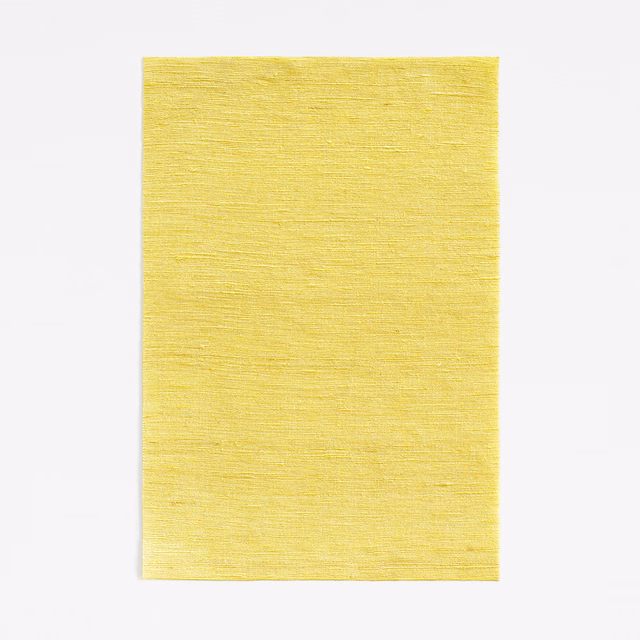 Citrine yellow fabric swatch with fine horizontal woven texture and softly varied surface
