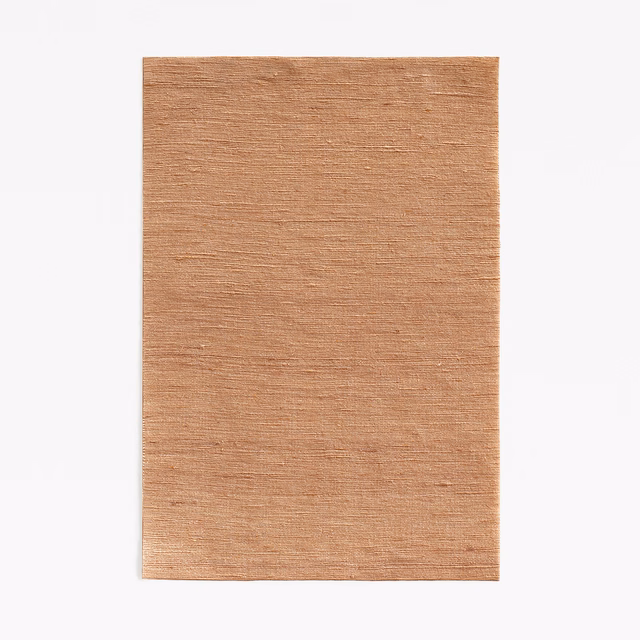 Muted burnt-terracotta fabric swatch with fine horizontal slub weave