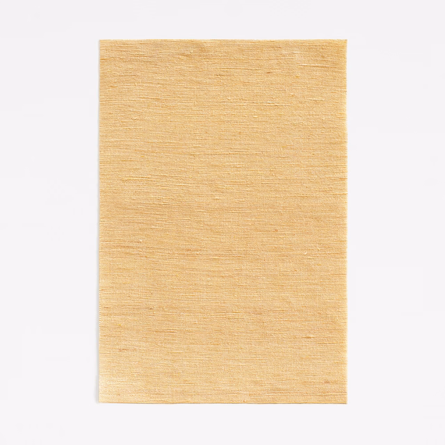 Pale maize yellow curtain fabric with fine horizontal woven texture and subtle golden variation
