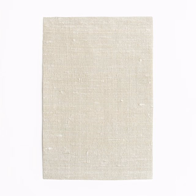 Pale greige woven fabric with fine horizontal texture, subtle slubs and ivory flecks