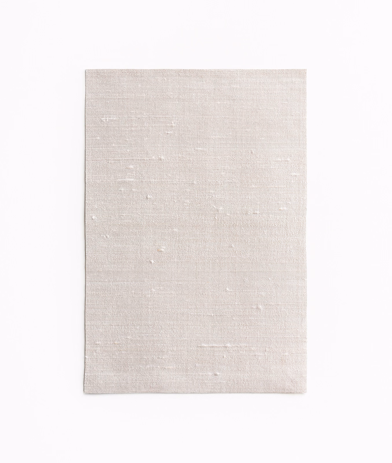 Pale pearl textile swatch with fine horizontal grain and tiny irregular flecks