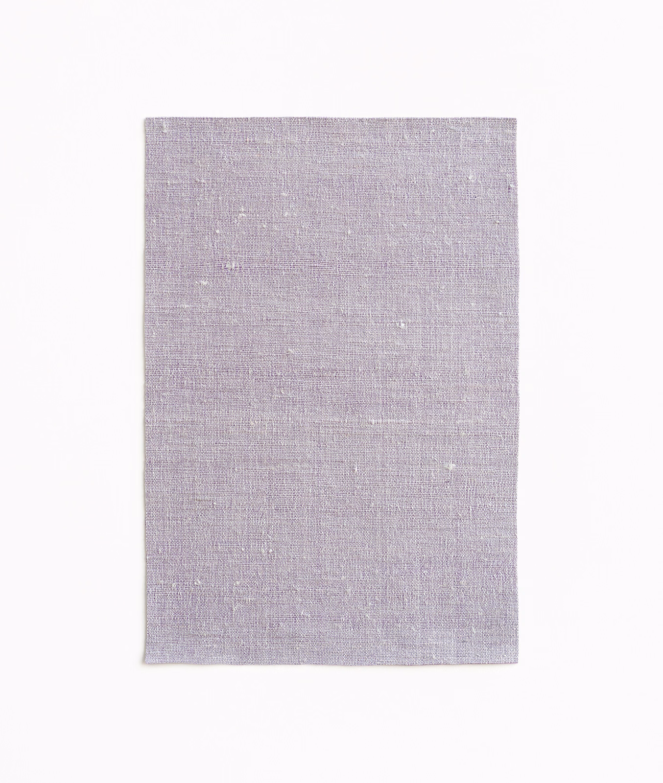 Pale greyed-lilac curtain fabric swatch with fine woven texture and subtle flecks