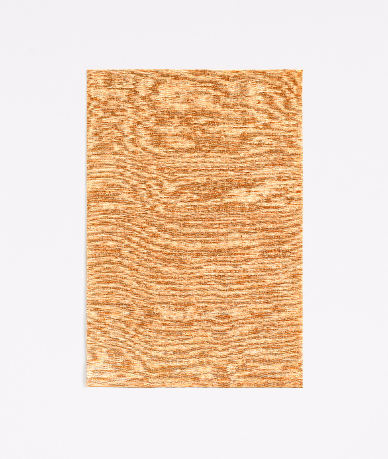 Warm copper-orange curtain fabric with fine horizontal slub texture