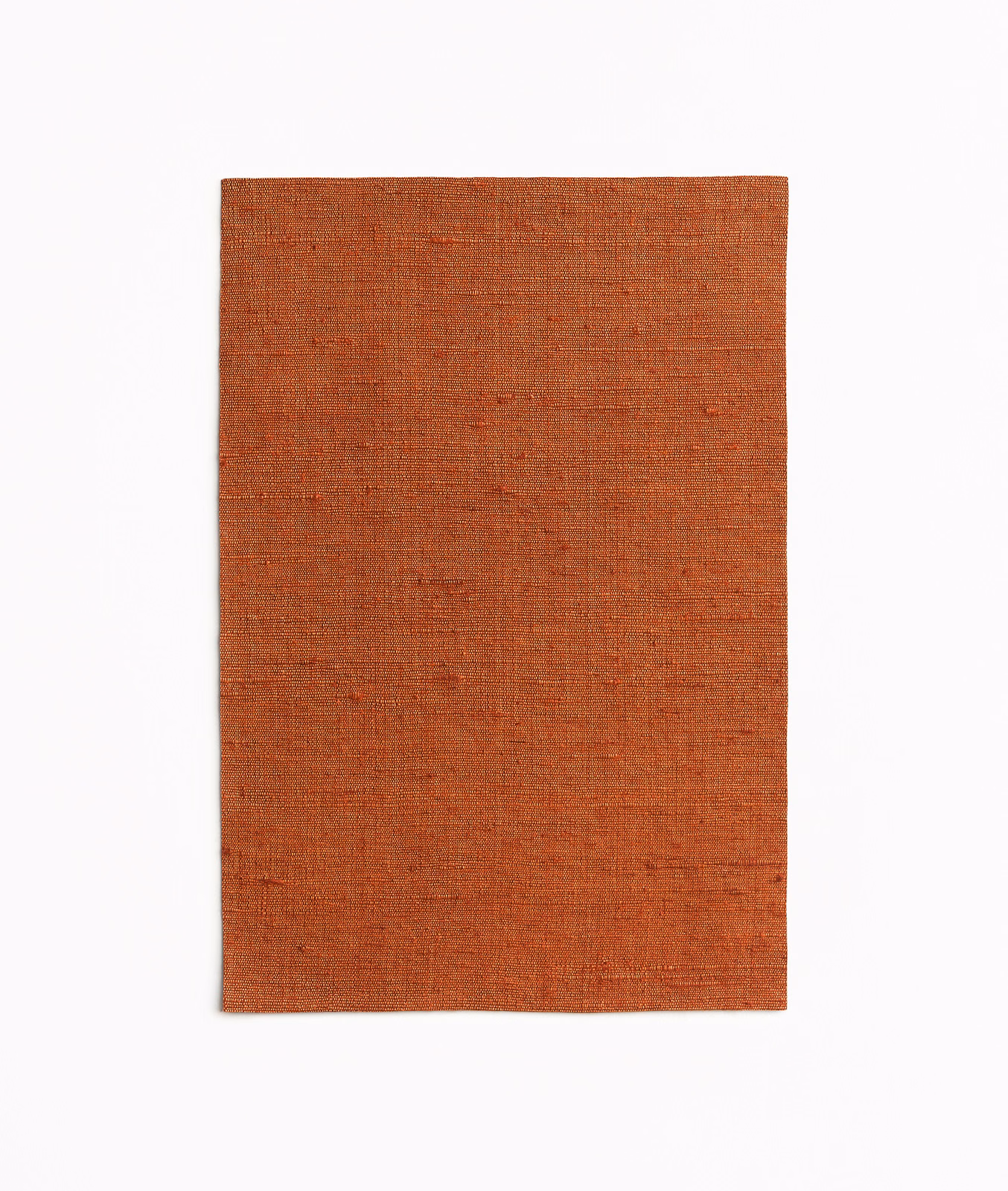 Burnt rust-orange curtain fabric with a fine, subtly irregular plain weave