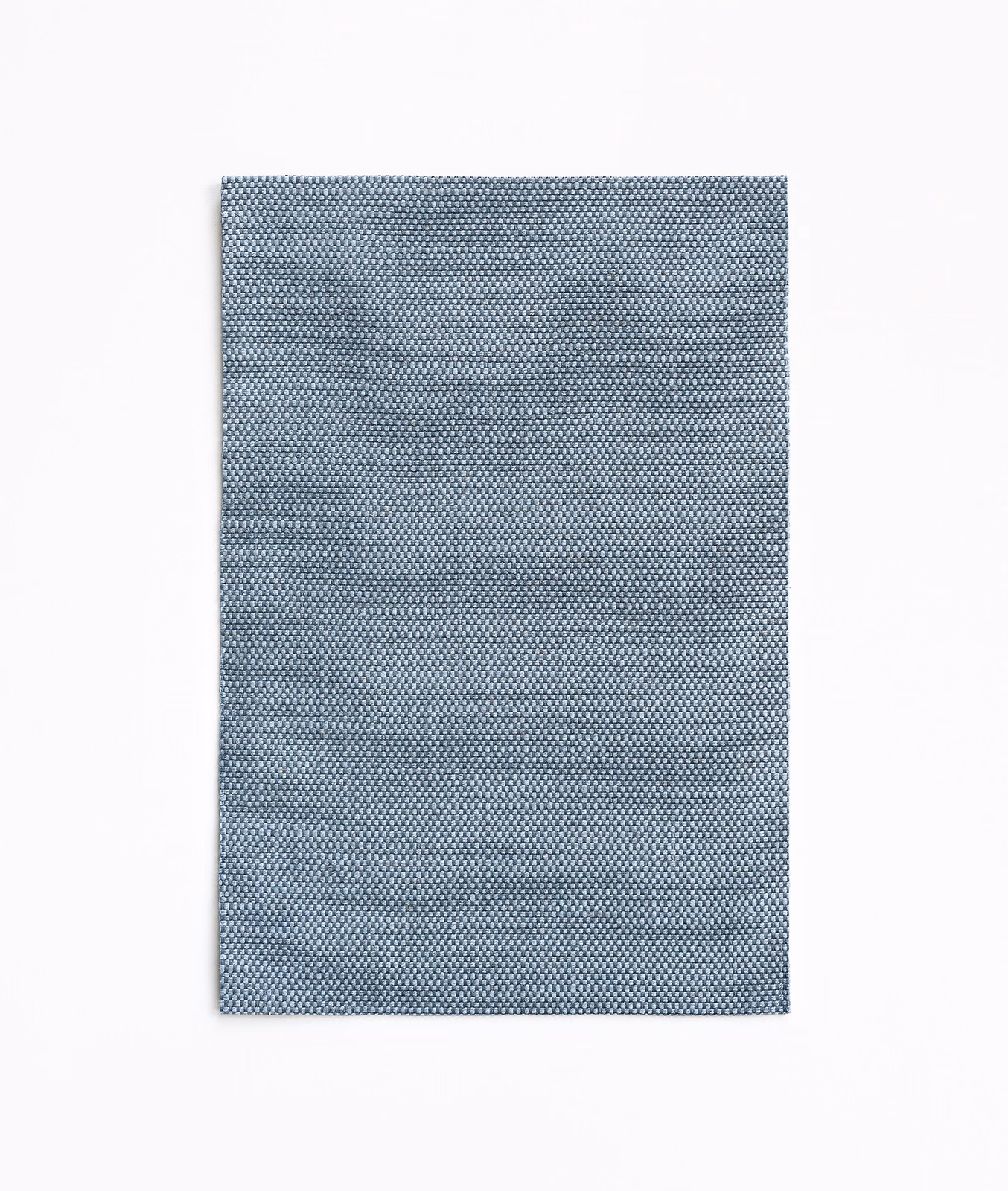 Muted blue-grey curtain fabric with a fine, densely woven micro-check texture