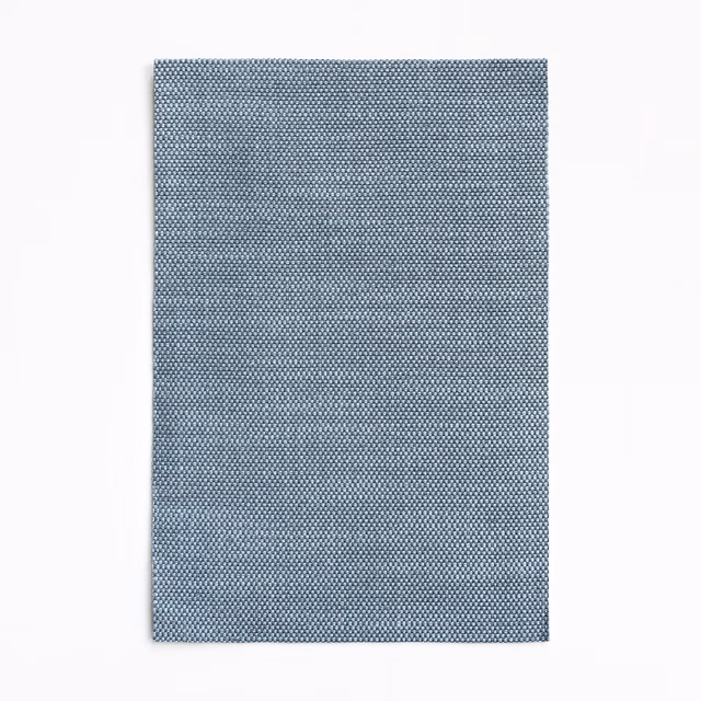 Muted blue-grey curtain fabric with a fine, densely woven micro-check texture