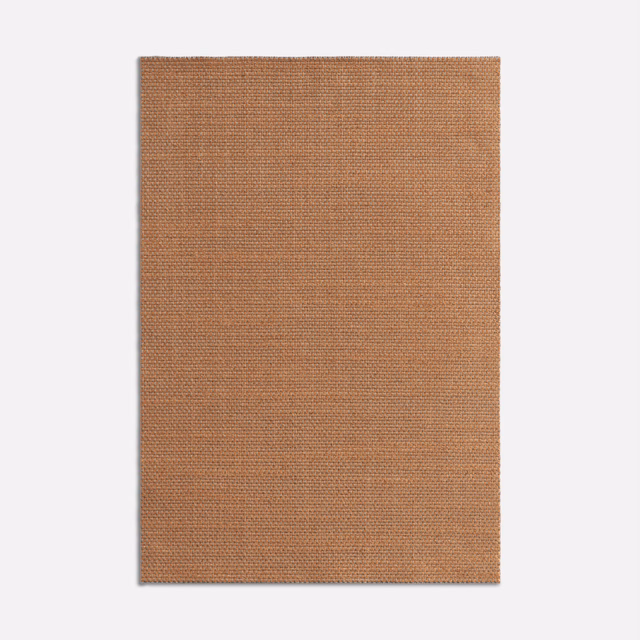 Close-up of warm terracotta fabric with a fine, even woven texture