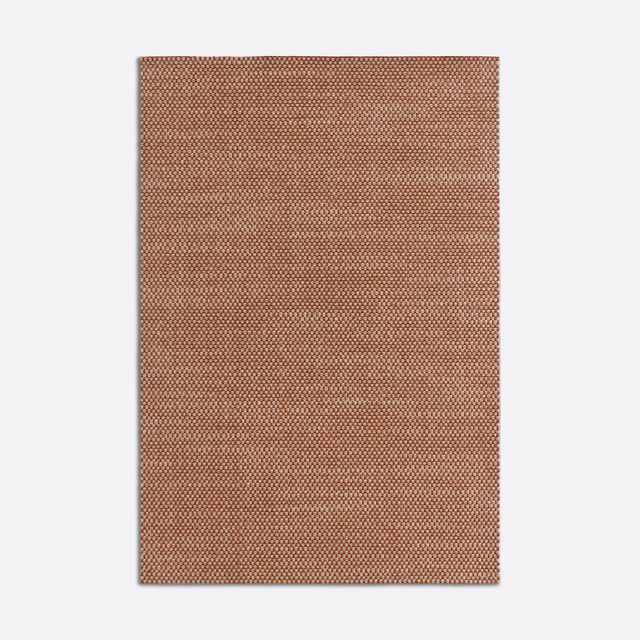 Warm tobacco brown fabric swatch with a dense tiny geometric woven pattern
