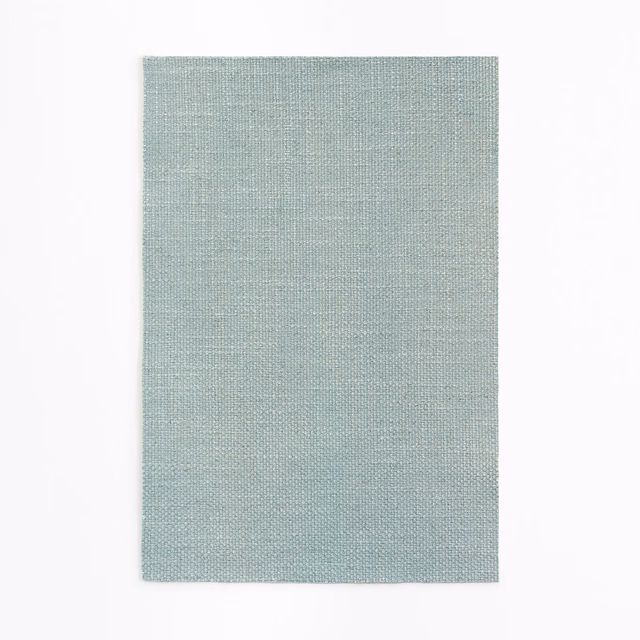 Pale aqua woven curtain fabric showing a fine blue-green crosshatch texture