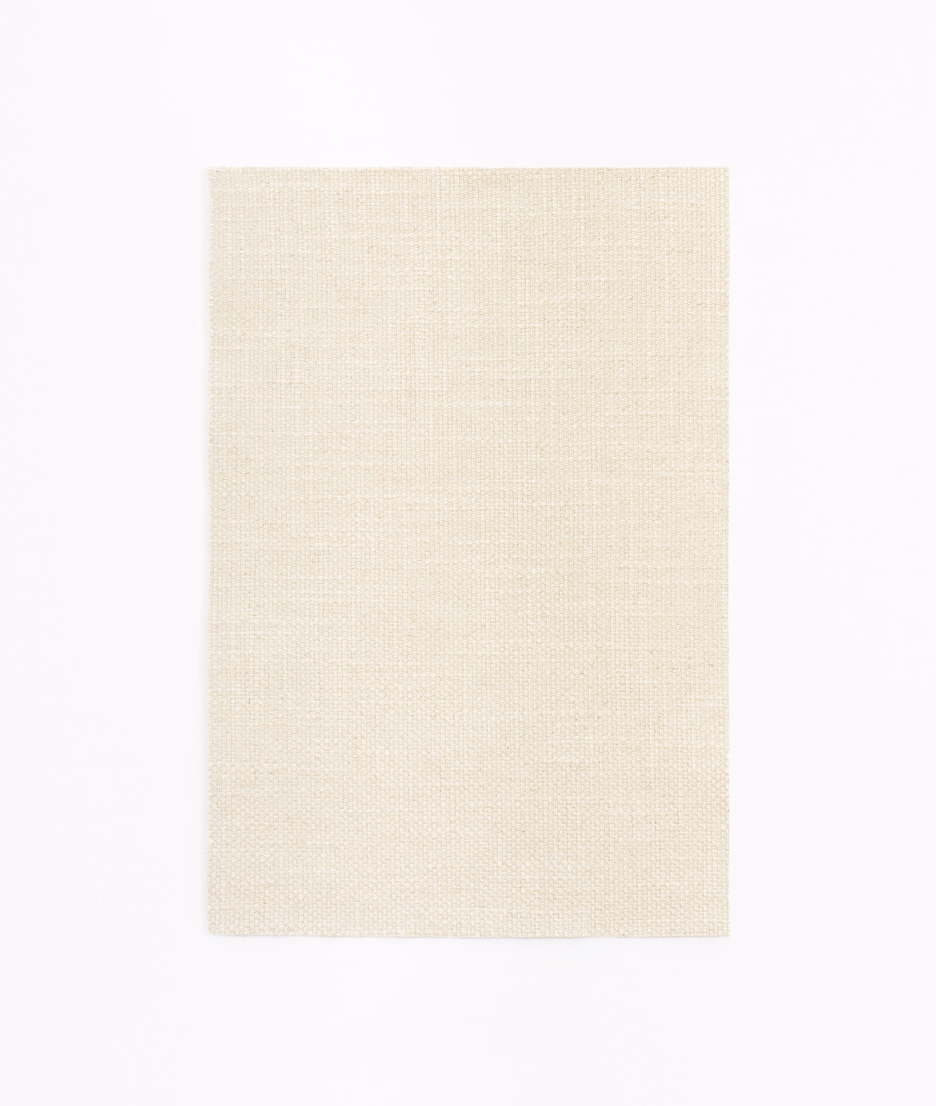 Close-up of soft ivory cream fabric with a fine, even plain weave