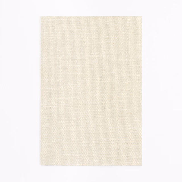 Close-up of soft ivory cream fabric with a fine, even plain weave