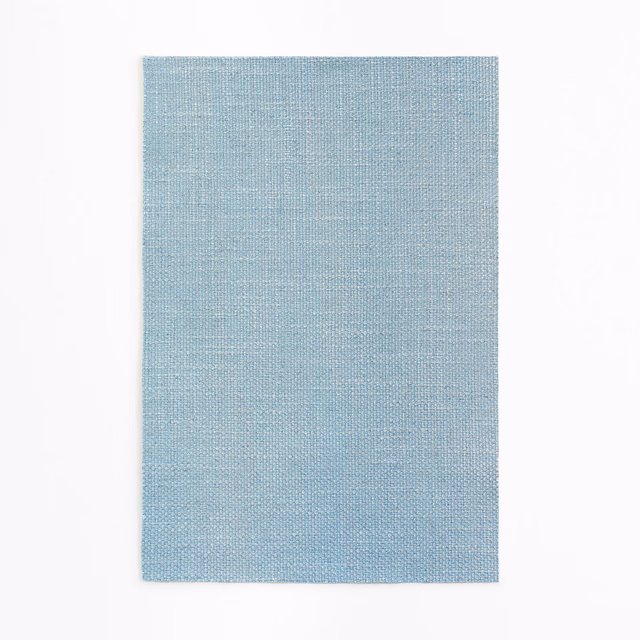 Powder-blue curtain fabric swatch showing a fine, even woven texture