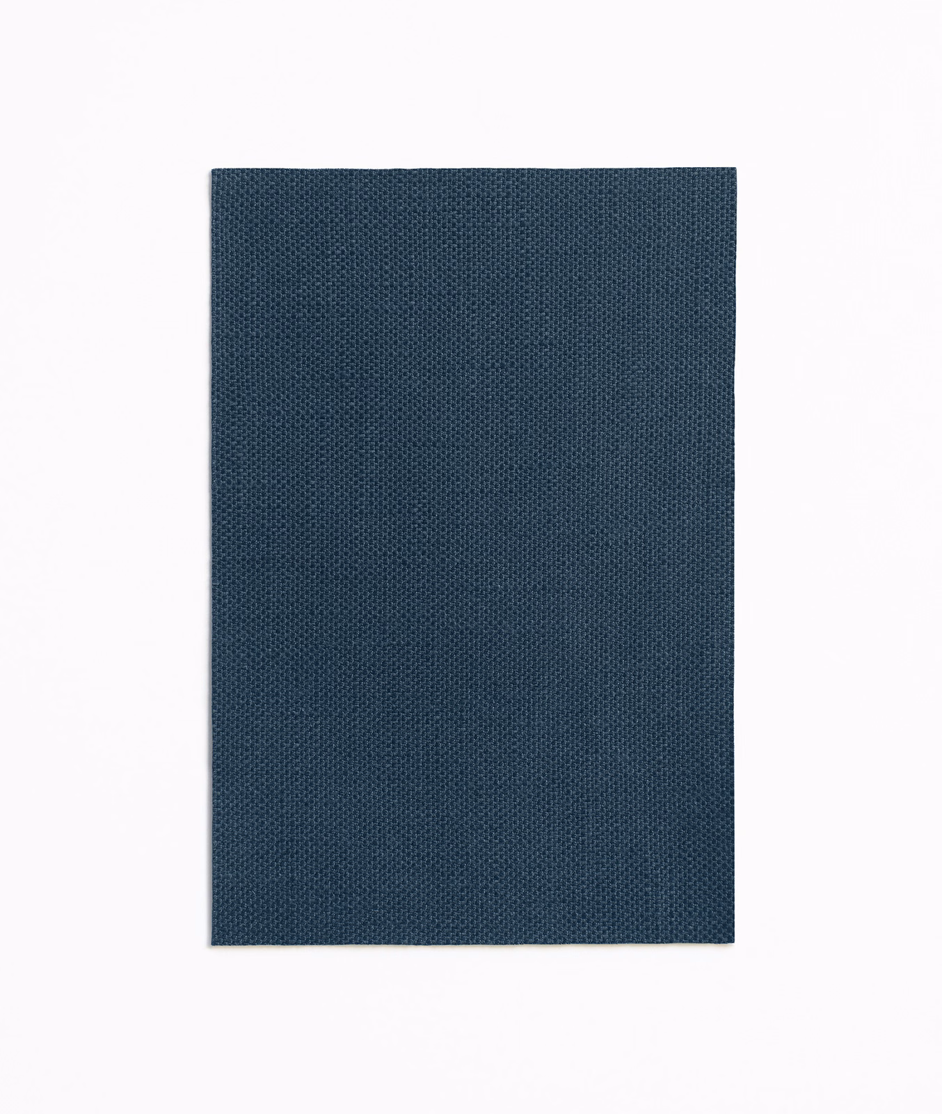 Deep indigo curtain fabric with a fine, evenly textured woven surface