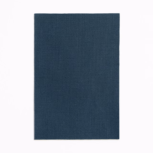 Deep indigo curtain fabric with a fine, evenly textured woven surface